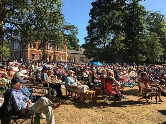 A packed audience enjoys a production of The Merchant of Venice in the sunshine at Lytham Hall
