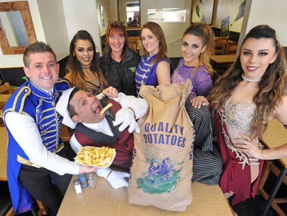 Chico the Clown from Circus Starr juggles potatoes donated by Harrowside Chippy in his act.  He is pictured with Joel Hatton, Gina Morales, Sue Miller from Harrowside Chippy, Ashleigh Hatton, Romy Bauer and Jacquie Morales.