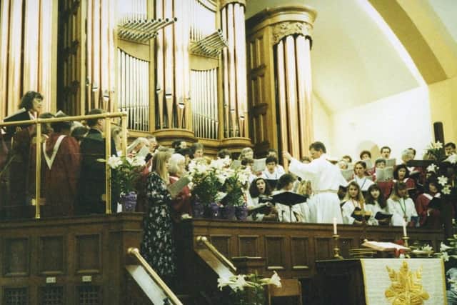 The choir sing in front of the listed organ.