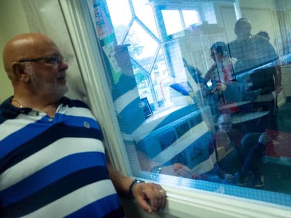 Gary Cattermole observes through Park Community Academys one-way window to see how his son, Connor, is learning