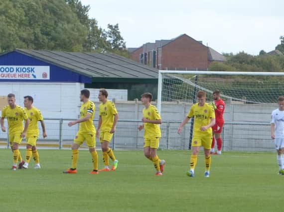 Taylor and Wallace (far left) pictured playing for Fleetwood in their Lancashire Senior Cup clash against AFC Fylde
