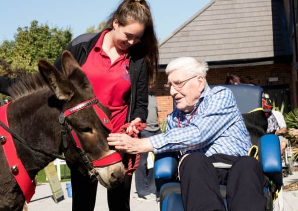 Resident Peter Hale with Sharlarna Kilfoyle from Dapper Donkeys at the first birthday celebration at the Hampton Care Centre, St Annes