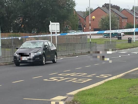 The scene of the accident, with the car involved and a pile of belongings in the road (Picture: Danny Cronin)