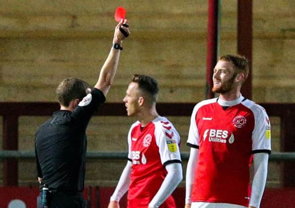 Referee Peter Wright shows Fleetwood Town's Cian Bolger the red card