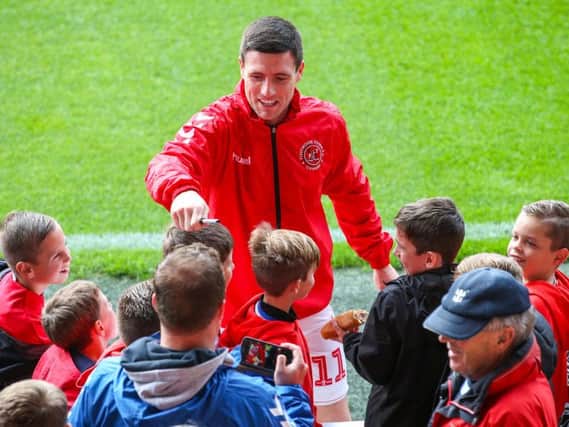 Fleetwood Town midfielder Bobby Grant chats with the fans after he was an unused sub in the Accrington game