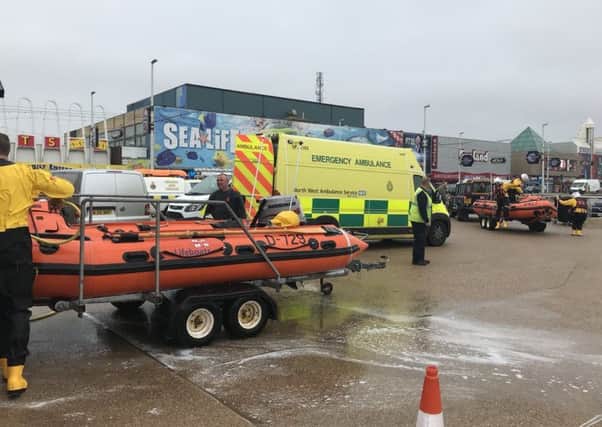 Am ambulance waits to take a casualty to hospital after they were rescued from the sea by Blackpool RNLI.