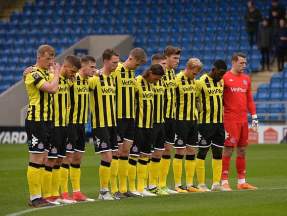 Fylde players observe a minute's silence for Karole Woodthorpe before kick-off Picture: STEVE MCLELLAN