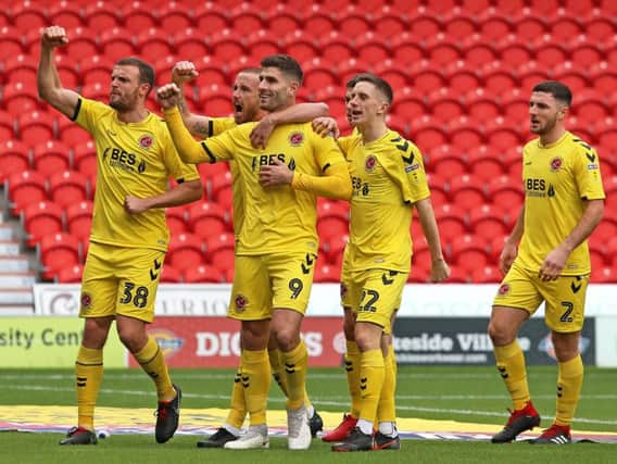 The Fleetwood Town players celebrate at Doncaster