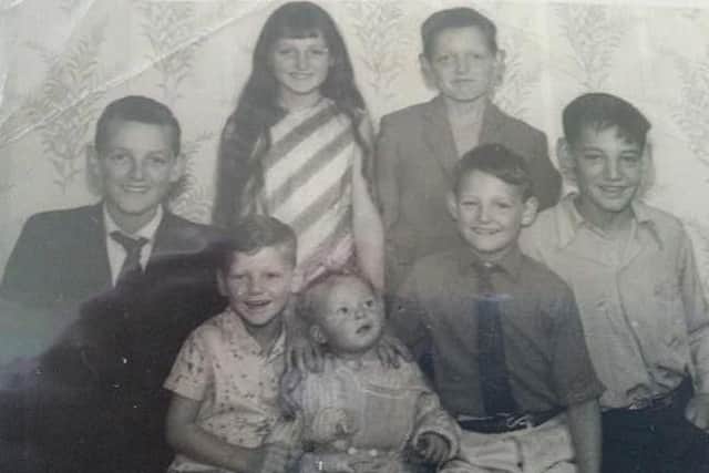 David, on the left, with his siblings.