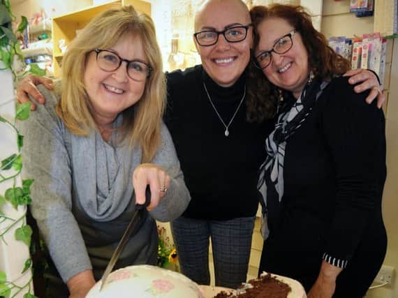 Friends of Toni Roddick, who is battling cancer, posed for a funraising Calendar Girls-style calendar and gathered at Iced in Garstang for its official launch. Toni (centre) with Gill and Lynne from Iced, who made a huge bra-shaped cake to help with fundraising.