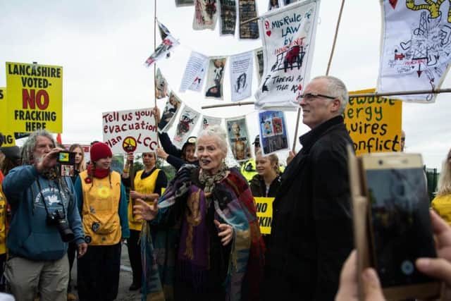 Dame Vivienne Westwood and her son Jo Corre with banners she helped design at the Preston New Road fracking site near Little Plumpton