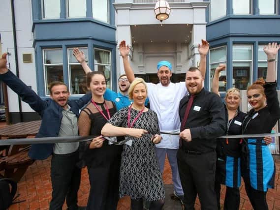 Stephanie Rukin and Chloe Rossall from Trinity Hospice cut the ribbon to reopen the Belle Vue pub