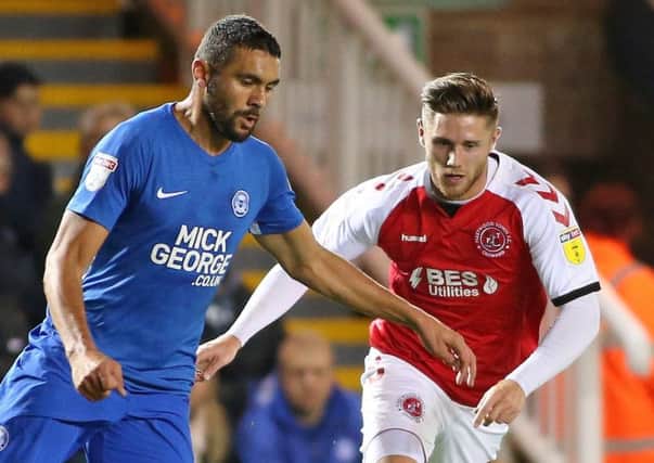 Fleetwood Town' Wes Burns chases down Peterborough United's Rhys Bennett
