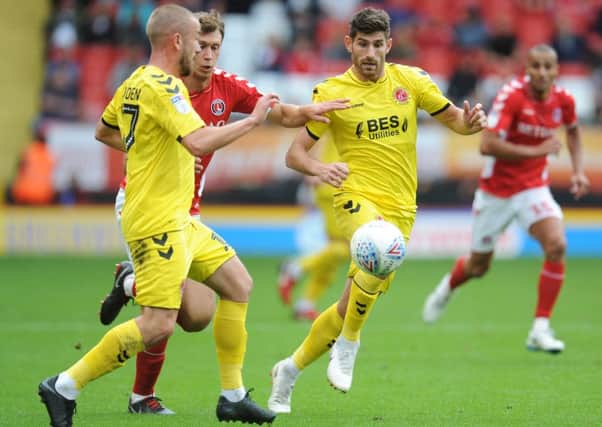 Fleetwood Town's Ched Evans and Paddy Madden vie for possession with Charlton Athletic's Krystian Bielik