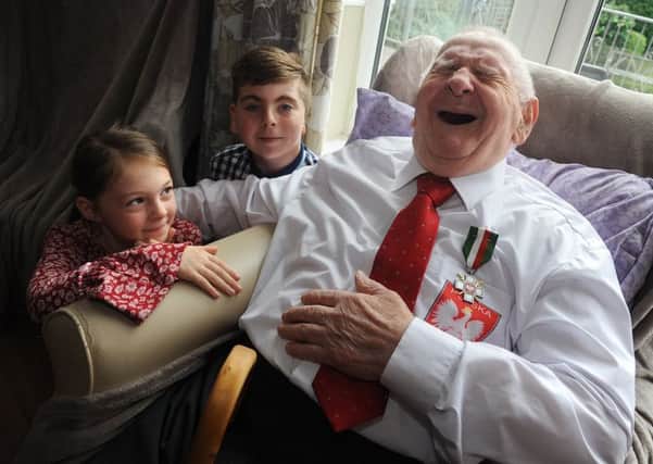 99 year-old Aleksander Chodasiewicz, a resident of the Rossendale Nursing Home in Ansdell, was presented with the Siberia Cross by the Polish government in honour of his bravery during the Second World War.
Consul General of the Republic of Poland Leszek Aleksander with his great-grandchildren and his medal.  PIC BY ROB LOCK
25-10-2018