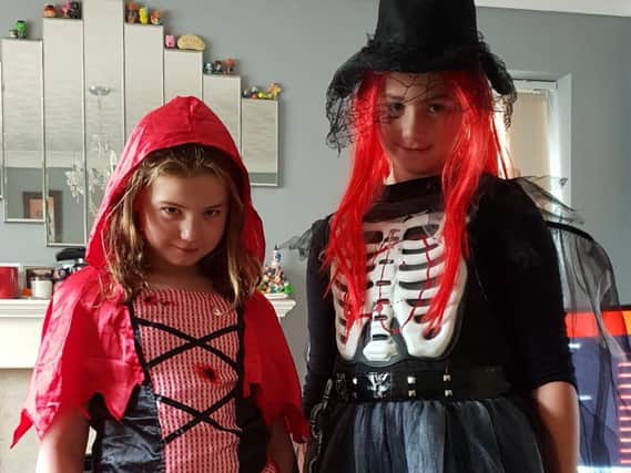 Scarlett Tushingham (right) and her sister Grace, ready for Halloween
