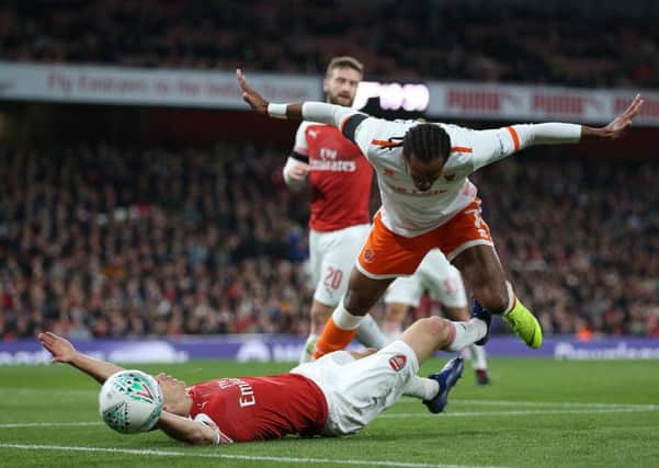 Arsenal's Stephan Lichtsteiner and Blackpool's Nathan Delfouneso battle for the ball