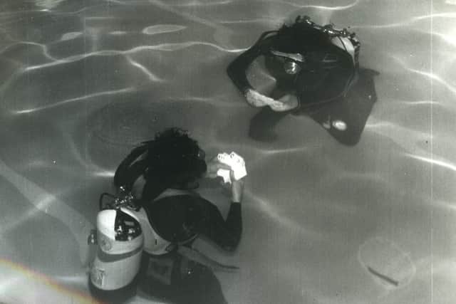A game of underwater cards for two members of the Blackpool and Fylde branch of the British Sub Aqua Club, who are in training for their attempt on the world record underwater endurance test - 50 hours. Brian Foulds (left) and Jim Whiteside are pictured at the Imperial Hotel pool, North Shore.