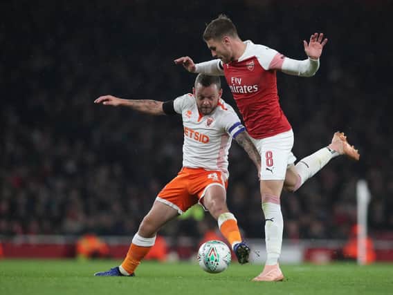 Jay Spearing tussles with Arsenal's Aaron Ramsey at the Emirates