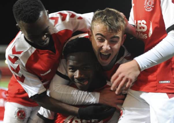 Fleetwood Town's Shayden Morris is mobbed by his team-mates after scoring