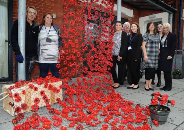 Volunteers have created an impressive display of poppies at the front the Blackpool Carers Centre on Newton Drive.
Volunteers Ken Robbins and Ann Hardisty (left) stand next to the main display with staff at the centre.  PIC BY ROB LOCK
25-10-2018