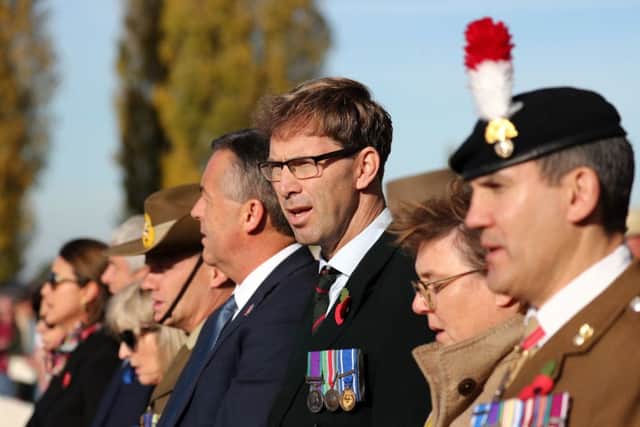 Tobias Ellwood, Minister for Defence People and Veterans at Tyne Cot Cemetery near Ypres, Belgium, during a commemoration and burial service for an unknown British soldier who was killed in the battle of Passchendaele 101 years ago. PRESS ASSOCIATION Photo. Picture date: Tuesday November 6, 2018. The unknown man, who served in the Lancashire Fusiliers regiment, is to be buried with full military honours alongside two Australian soldiers. See PA story MEMORIAL Soldier. Photo credit should read: Gareth Fuller/PA Wire