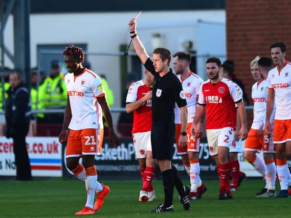 Referee John Brooks shows a red card to Blackpool's Armand Gnanduillet during the 3-2 defeat at Fleetwood