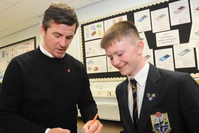 Joey Barton signs an autograph for pupil Jay Fitzgerald, 15