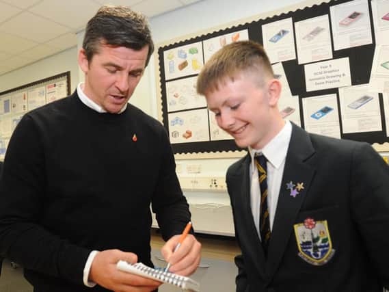 Joey Barton signs an autograph for pupil Jay Fitzgerald, 15