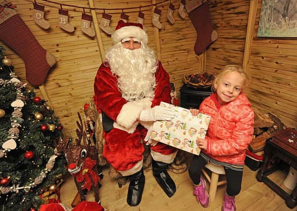Children from Brian House visit Santa's Grotto at Jellytots.  Pictured is 6-year-old Nicole Russell wth Santa.