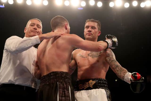 Cardle embraces Burns after the fight is stopped