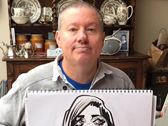 Caricature artist Chris Knapman with one of his cartoons done "live"