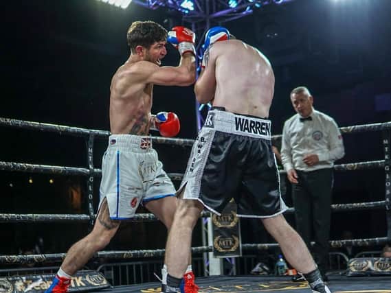 Brian Rose on the offensive against Alistair Warren on his return to the ring. Picture: Chris Roberts for MTK Global