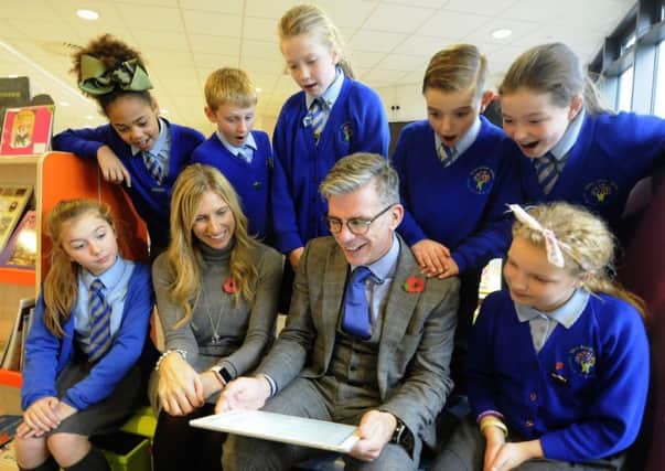 Staff and pupils at Layton Primary School are celebrating after being judged outstanding by Ofsted. Deputy headteacher Claire Jones and headteacher Jonathan Clucas go over the report with pupils.