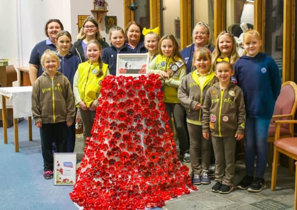 The 9th Blackpool Brownies and Guides created a tribute out of hand painted, recycled empty bottles in Holy Cross Parish Church. Pic by Joe Hoover