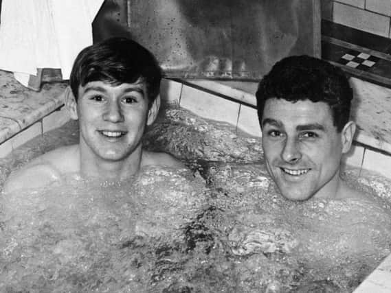Manchester City players David Wagstaffe (left) and Barrie Betts pictured in 1962 taking tonic treatment under the supervision of Mr J H Fearn at Buxton's Thermal Baths
