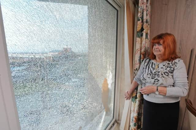 Rita Birch stands next to the shattered window which is in her terminally ill husbands room