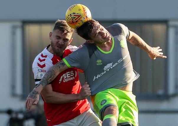 Fleetwood Town's Ashley Eastham competing with Walsall's Andy Cook