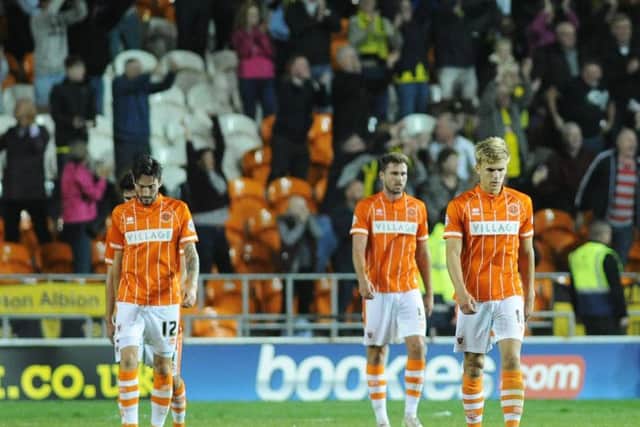 Connor Oliver, Clark Robertson and Brad Potts look dejected following Burton Albions winning goal