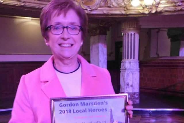 N-Vision charity chief executive Ruth Lambert with the award to recognise the work of the late Keith Gledhill who supported the charity's talking newspaper