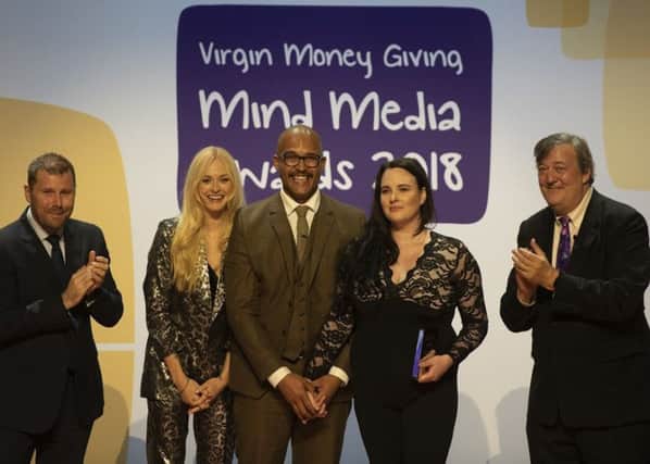 Clarke Carlisle and wife Carrie are presented with the Speaking Out award at the annual Mind Media Awards