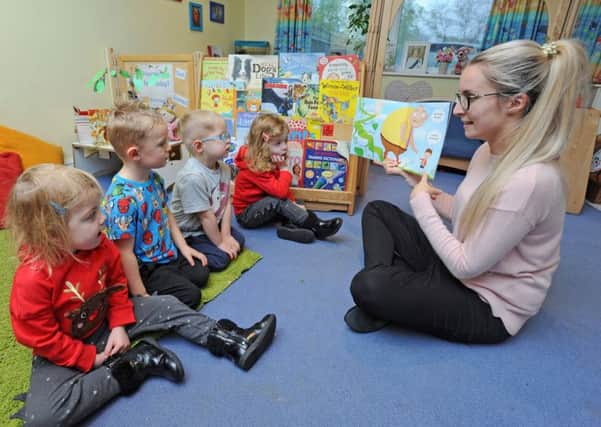Shepherd Lodge Day Nursery in St Anne's Road has been rated outstanding by Ofsted.  Pictured is pre-school teacher Emily Clymer reading to some of the children.