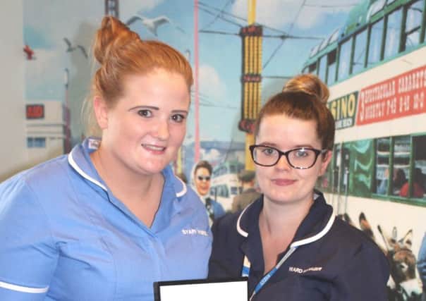 Lizzie Slater, left, receives her Cavell Star Award from Ward Manager, Gemma Smith at Blackpool Victoria Hospital