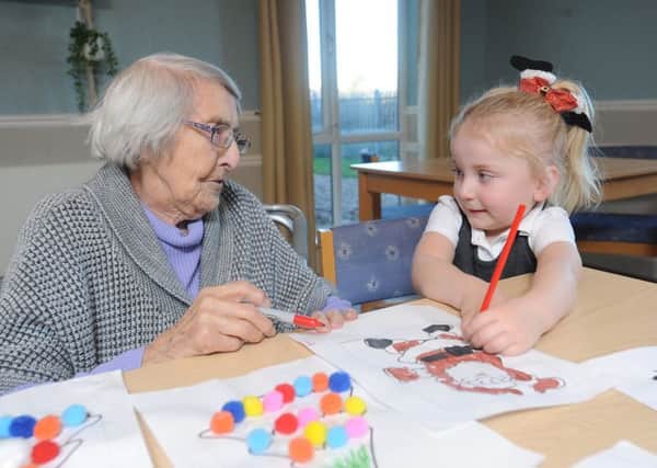 Children from Little Angels Nursery regularly pay a visit to residents at Amber Court Care Home.  4-year old Robynne Ratcliffe with resident Lisa Hessey.