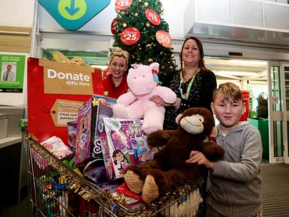 Layla Challoner and Janine Bezance with five-year-old Jack Lloyd, who was donating a teddy to Asda Fleetwoods Christmas Gift Appeal in aid of Fylde Coast Womens Aid.