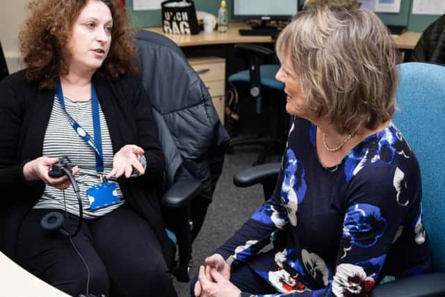 Dame Esther Rantzen, founder and President of the Silver Line charity talking with employee Lisa Grupman about her work taking telephone calls from older people