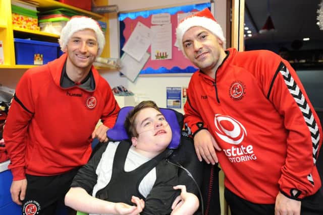 Fleetwood Town FC visit children and staff at Brian House Children's Hospice.  Jason Holt and Ross Wallace with 15-year-old Jack Taylor.