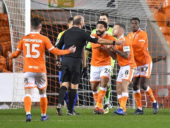 Blackpool players remonstrate with referee Andy Haines after he awards Solihull a penalty