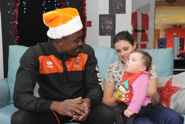 Joe Dodoo with student nurse Sophie Remnant and 18-month-old Matilda James