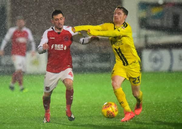 Fleetwood Town's Jason Holt vies for possession with Burton Albion Stephen Quinn